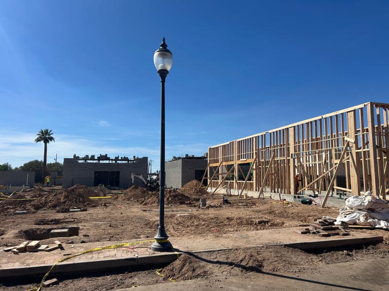 Wood framing going up on the Jefferson House buildings around the courtyard lamppost, March 2026