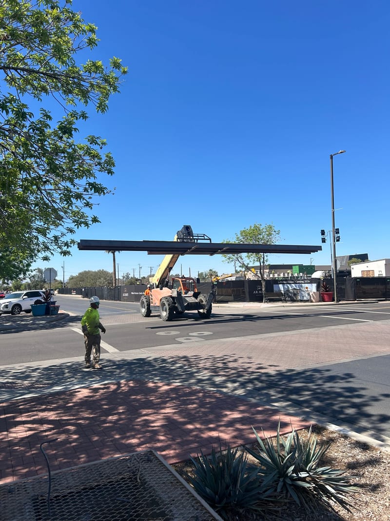 A telehandler setting a long steel beam at the Jefferson House construction site